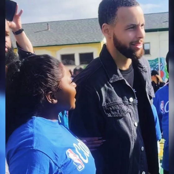A young guest in a blue event T-shirt at an outdoor community event on Valentine’s Day 2025